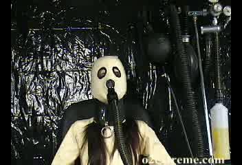 The Breathing Machine - In this video update lana dressed in compleate white catsuit and hood is strapped to the chair. Her mask is then hooked upto the breathing machine, where there is a good mix of air and other aromas in there. Her objective was simple everytime the breathing bag fills empty it!!